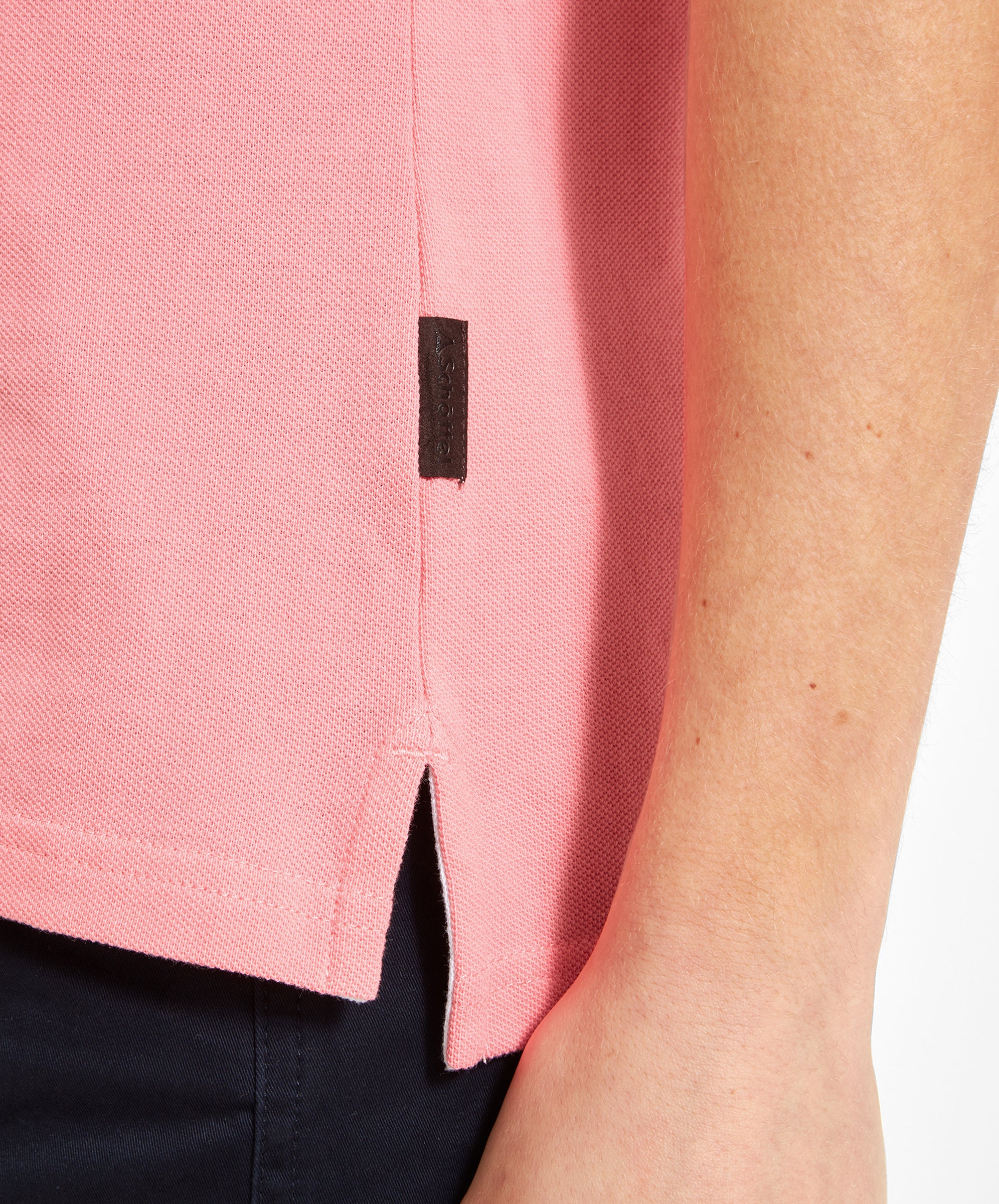 Detail of the Schöffel Women's St Ives Polo Shirt for Women in Pink side seam and logo tag.