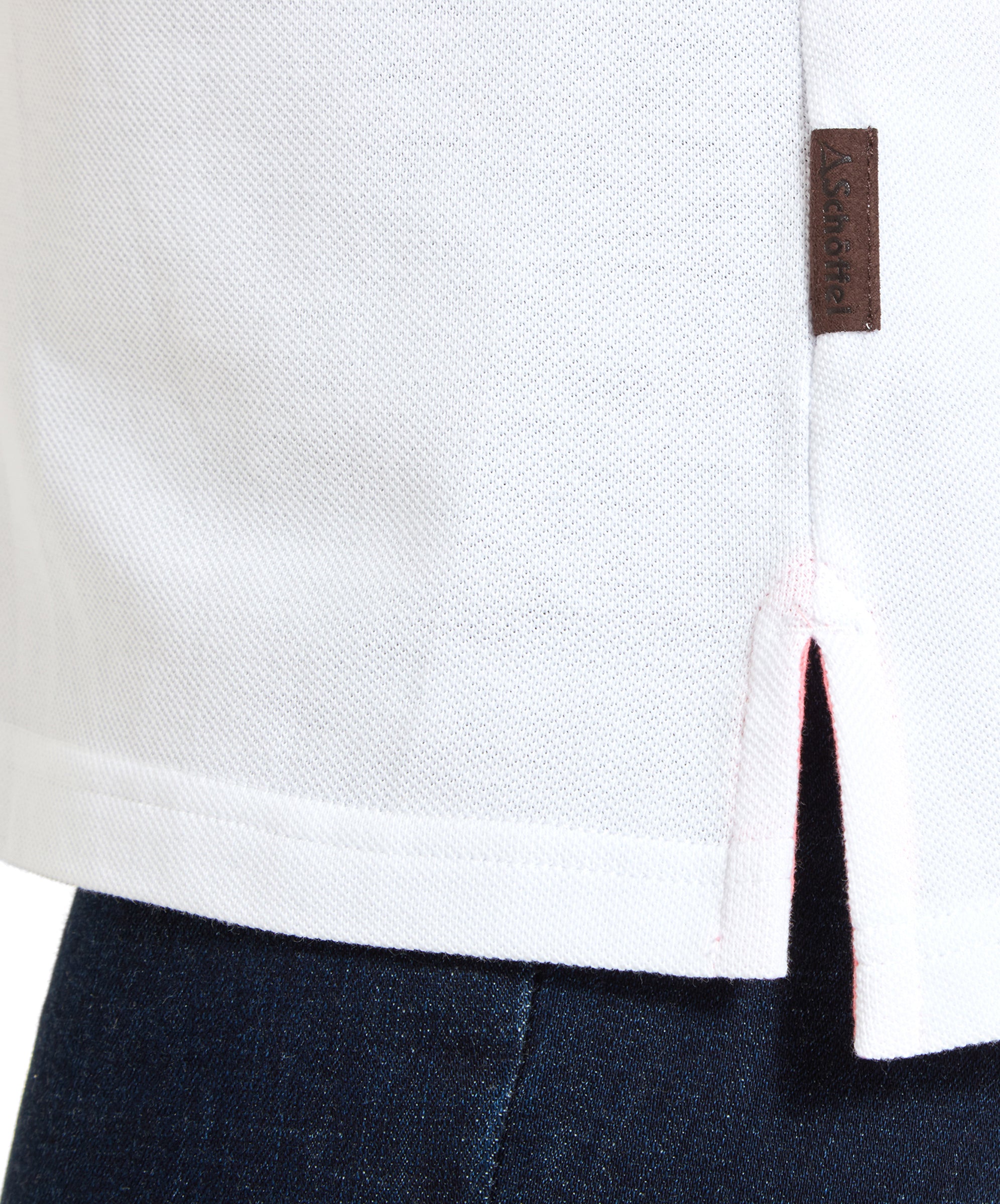 Detail of the Schöffel Women's St Ives Polo Shirt for Women in White side seam and logo tag.