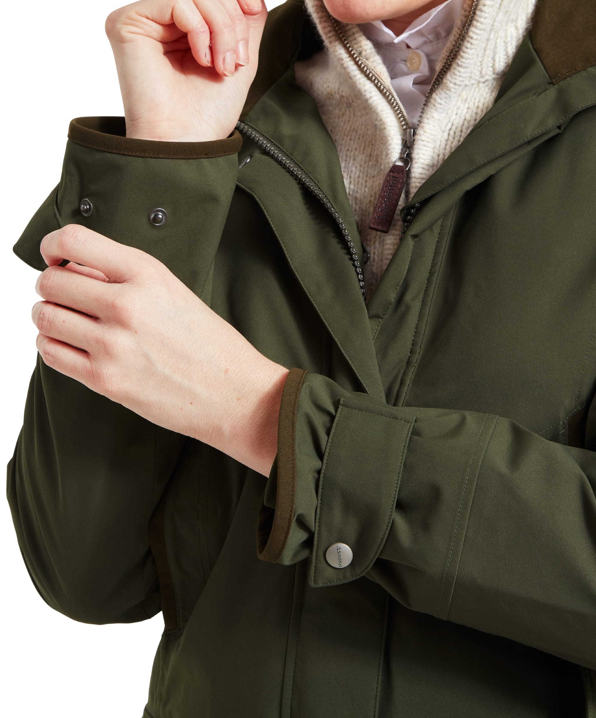 A close-up shot focuses on the cuff of the Schöffel Teal Ultralight Coat for Women in Green. The sleeve is secured with a snap button strap, and the fabric appears durable and weather-resistant. The image highlights the attention to detail in the jacket’s design.