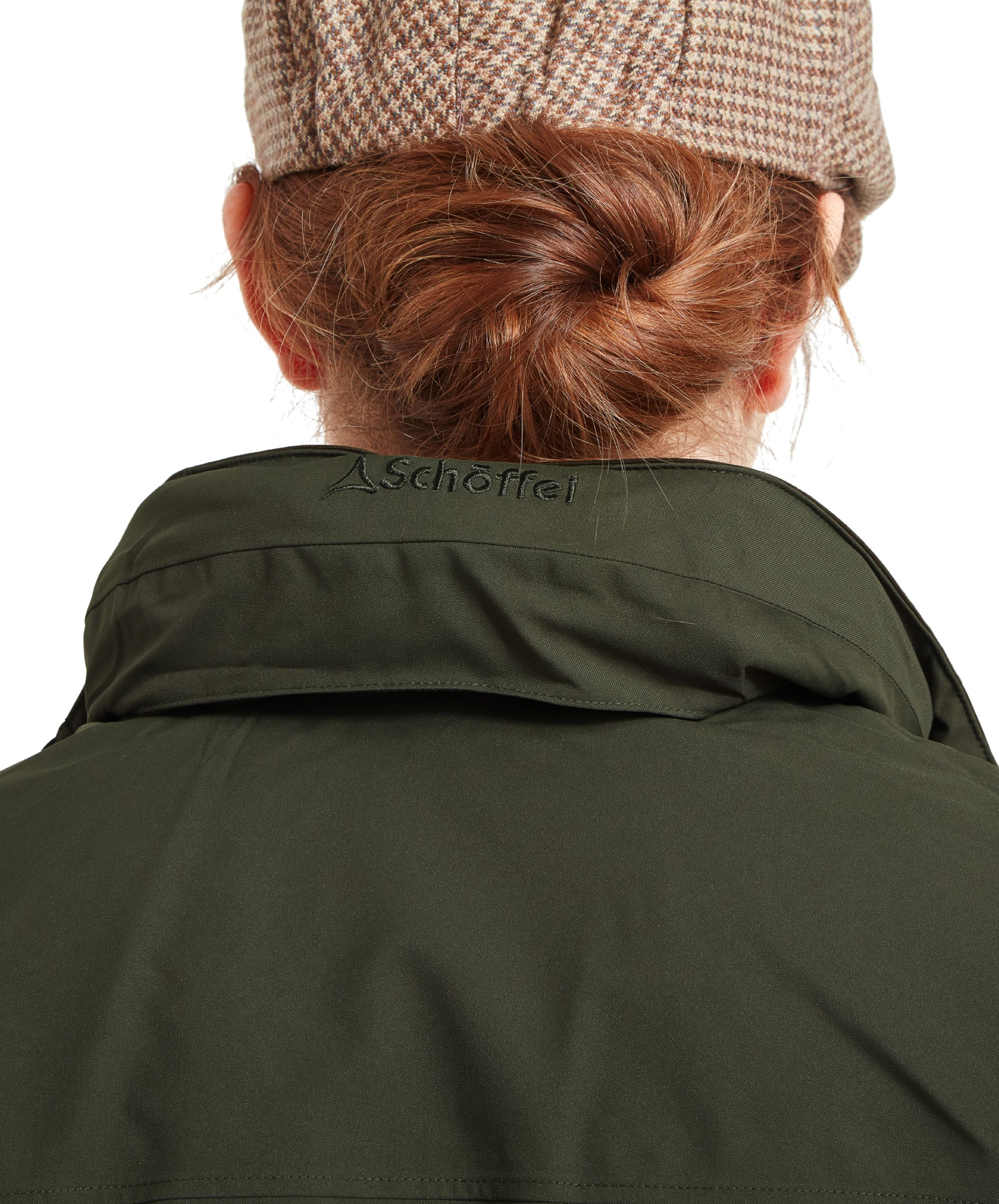 In this image, the hood of the Schöffel Teal Ultralight Coat for Women in Green is tucked away, and the back of the collar is visible, featuring a subtle embroidered logo. The collar is slightly raised, adding to the jacket's protective features.