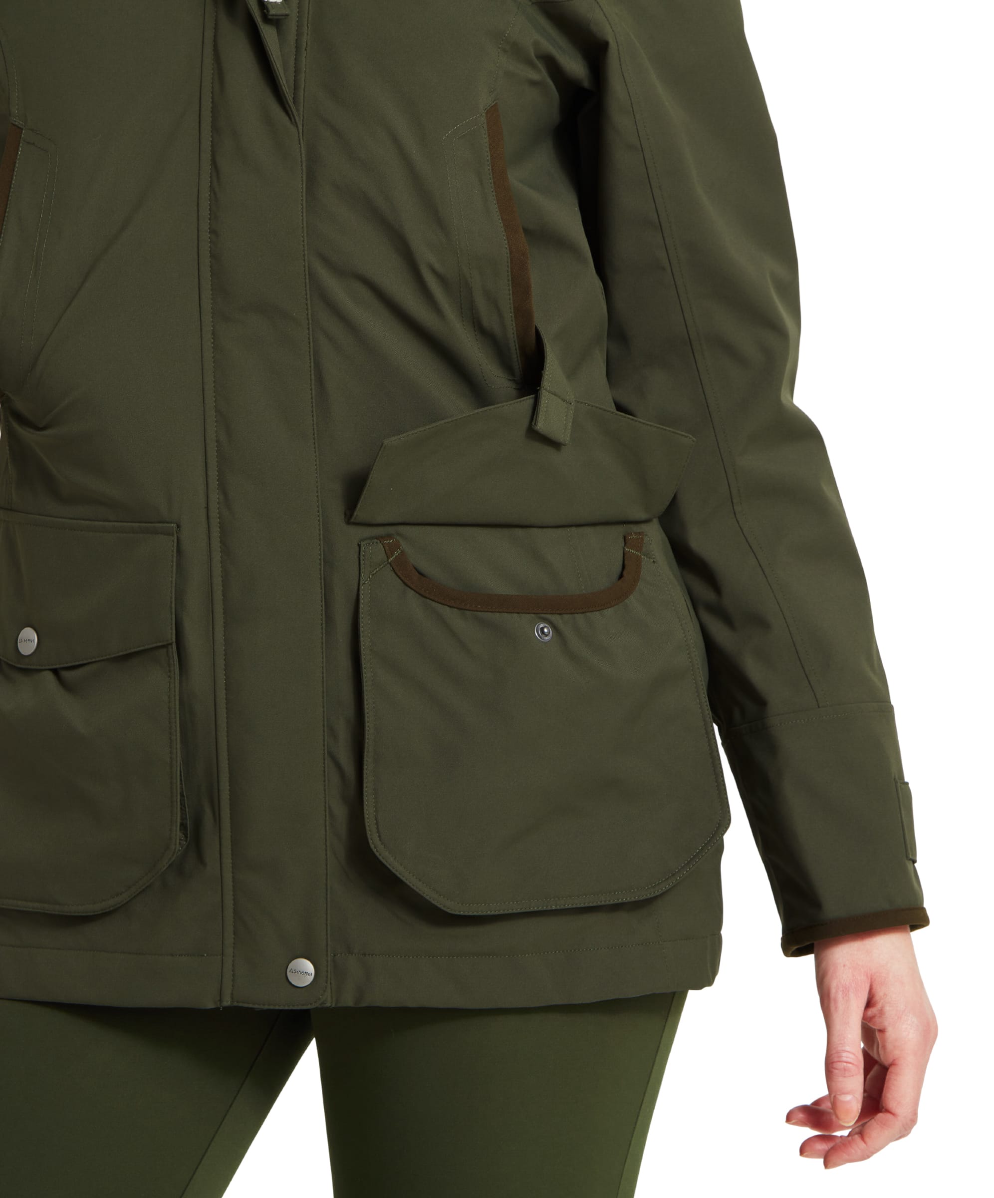 This close-up shows one of the Schöffel Teal Ultralight Coat for Women in Green’s front pockets, highlighting a retainer strap above the flap, adding functionality and style. The pocket is spacious and reinforced, suitable for carrying small items securely.