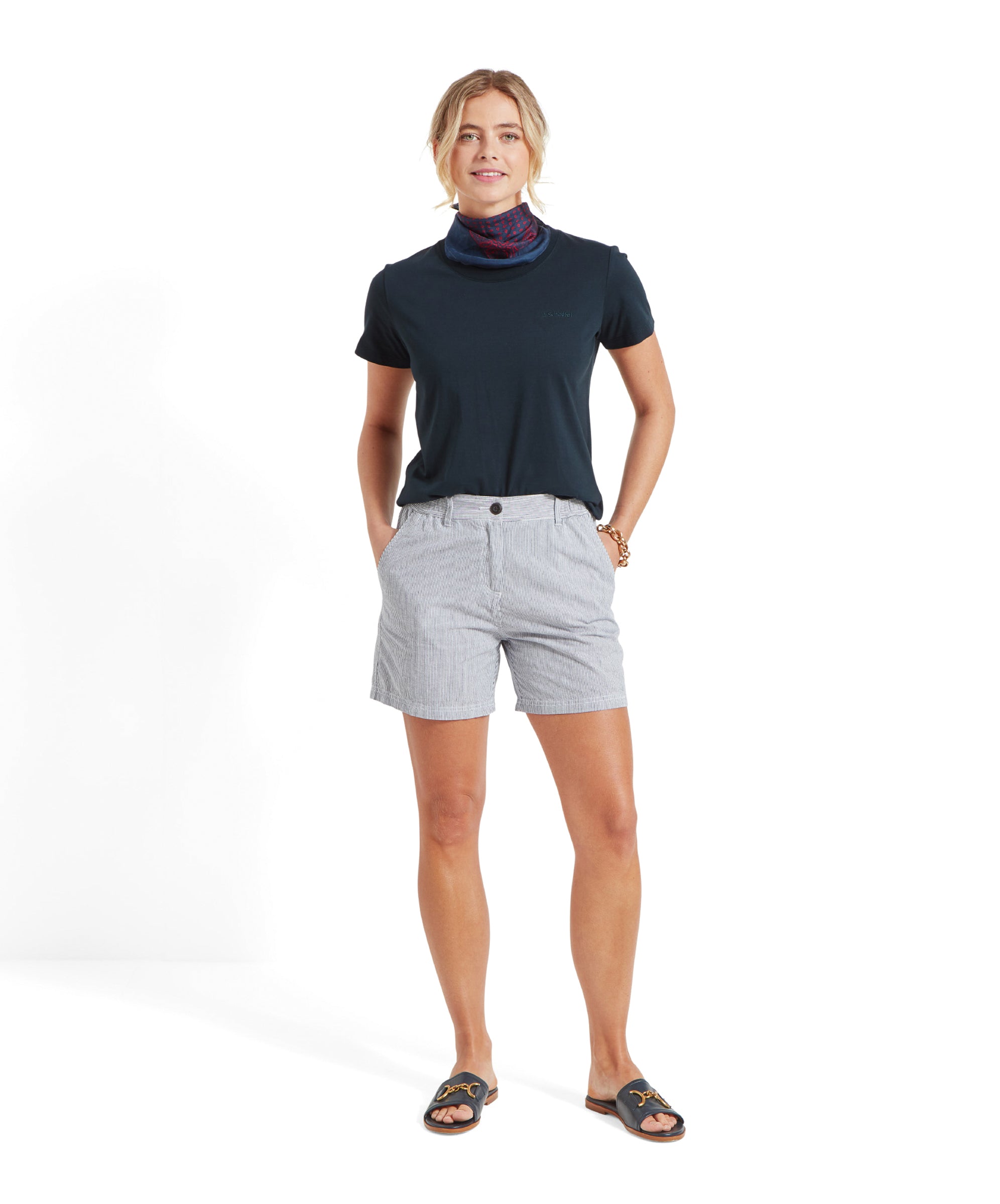 Full view of the woman in the Schöffel Tresco T Shirt for Women in Navy with striped shorts.