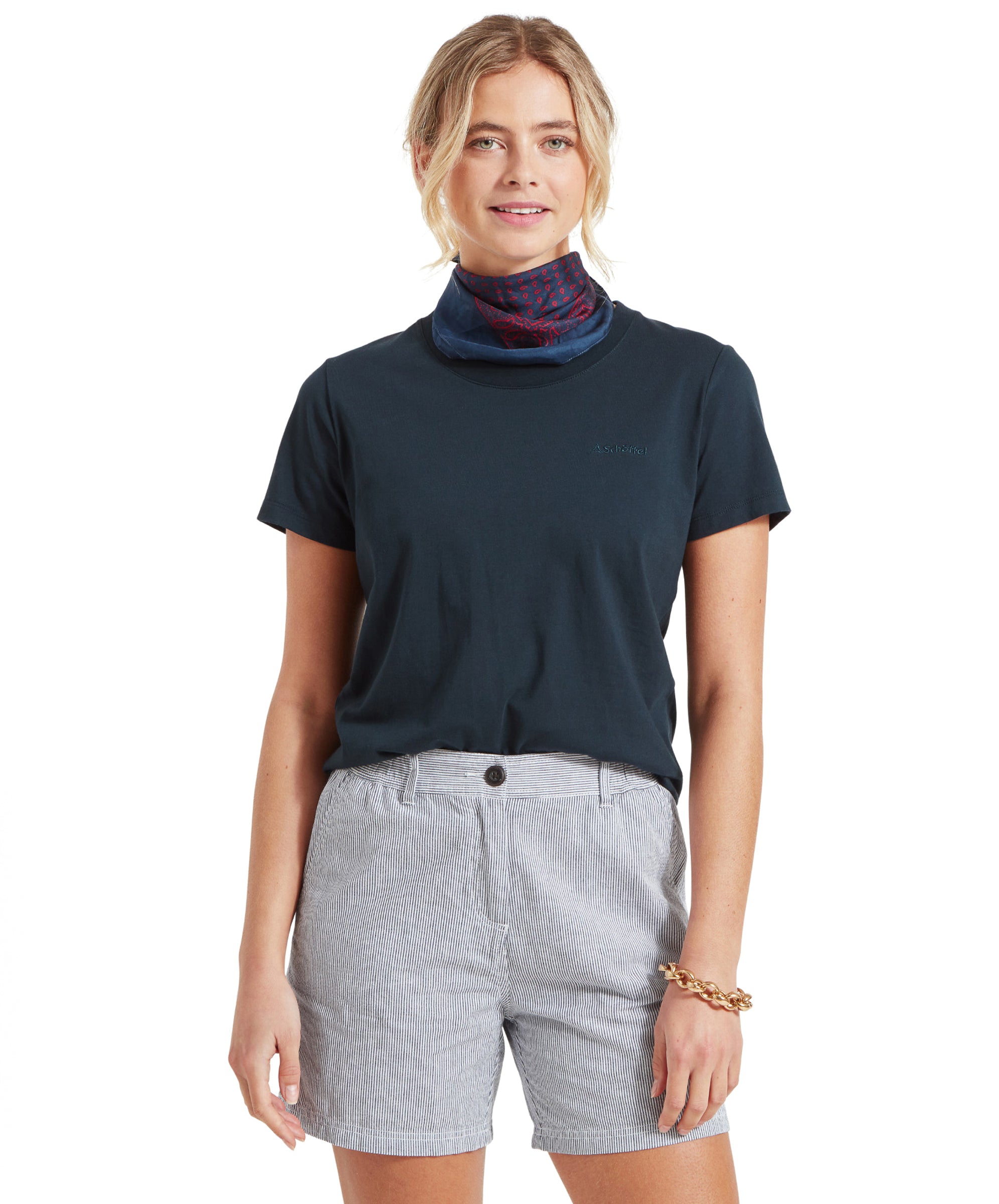 Another full view of the woman in the Schöffel Tresco T Shirt for Women in Navy and striped shorts.