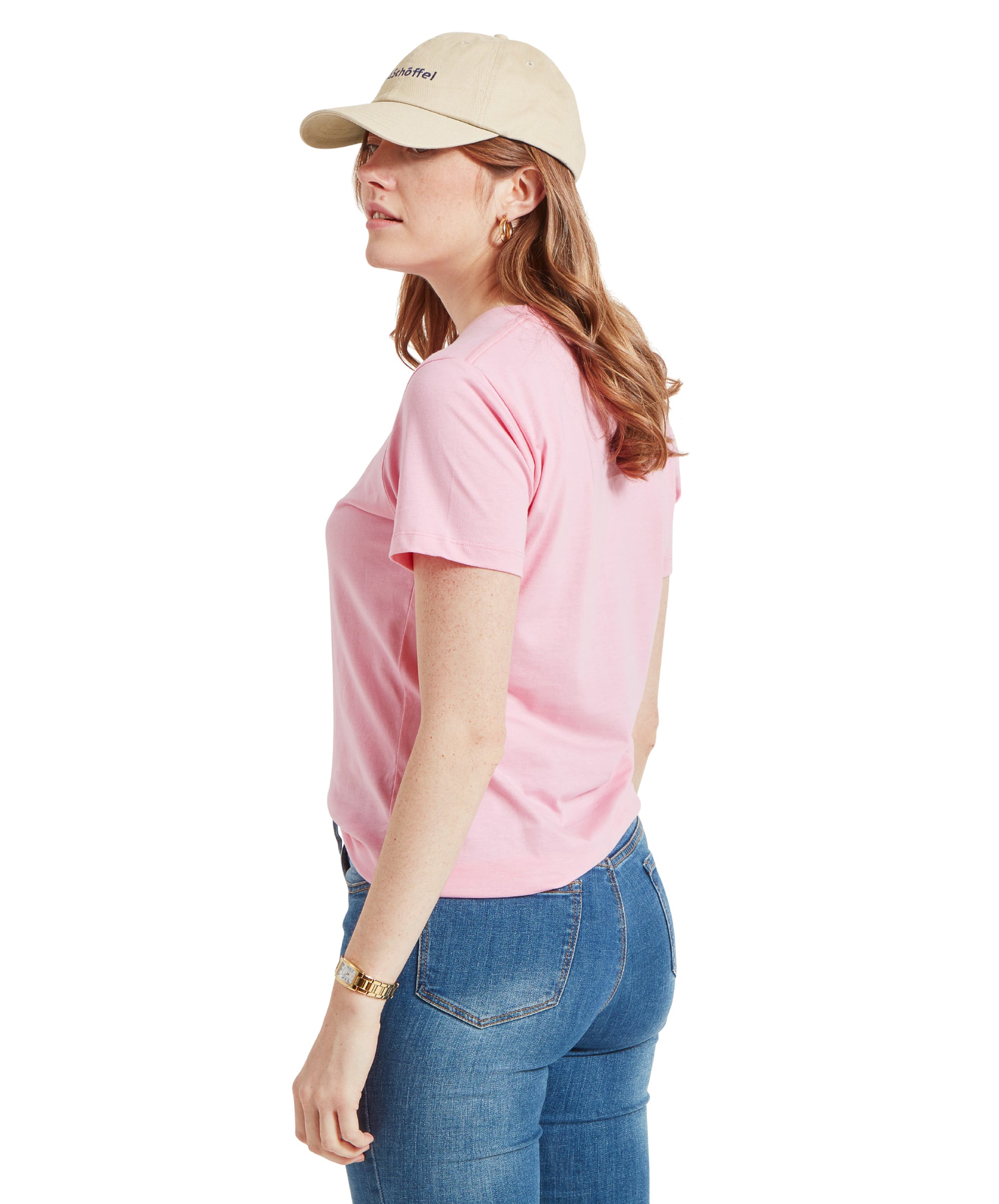 Side view of the model in Schöffel Women's Tresco T-Shirt in Pink, showcasing the side profile and cap.