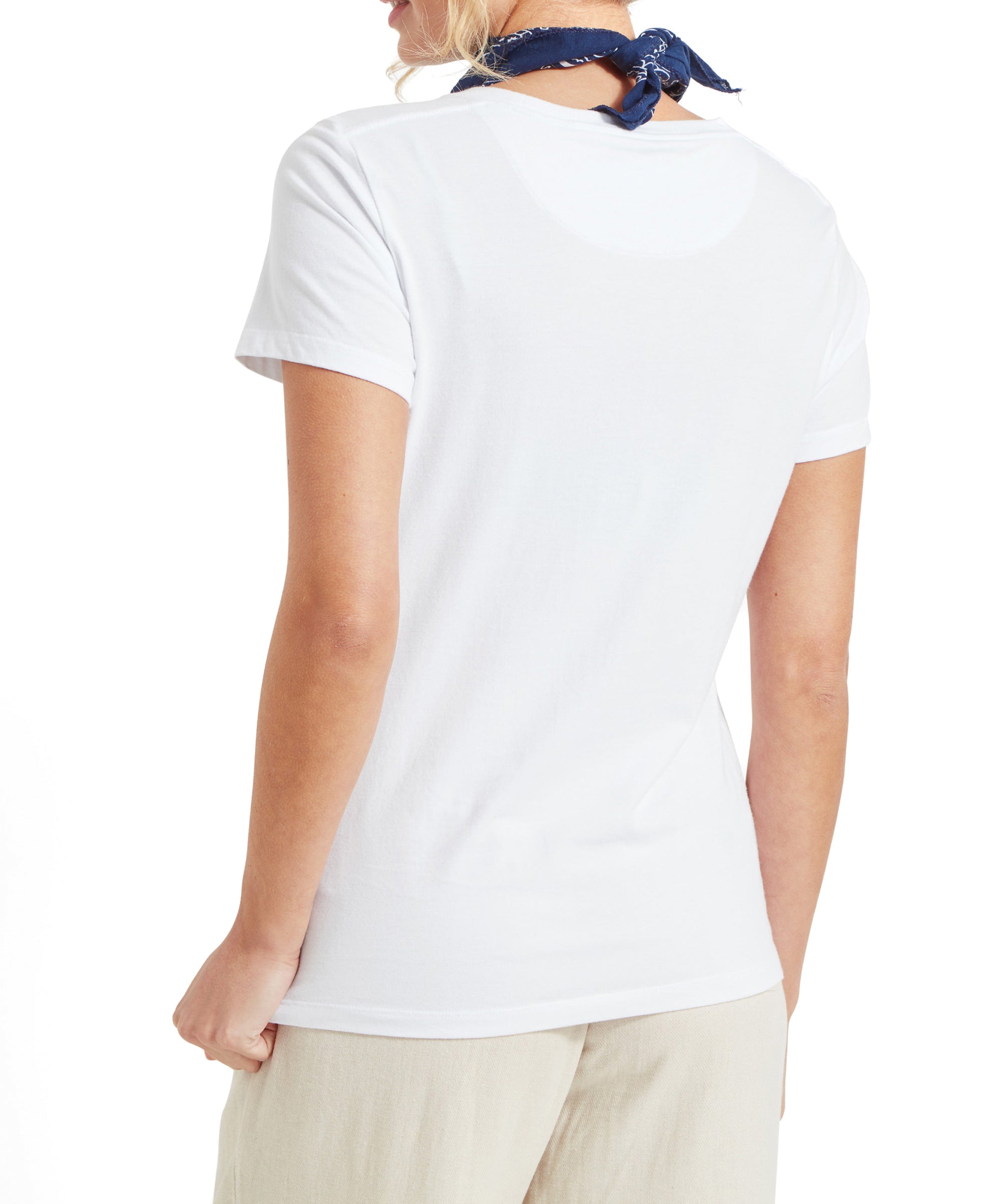 Back view of the Schöffel Tresco T Shirt for Women in White, showing the full shirt and beige wide-leg trousers.