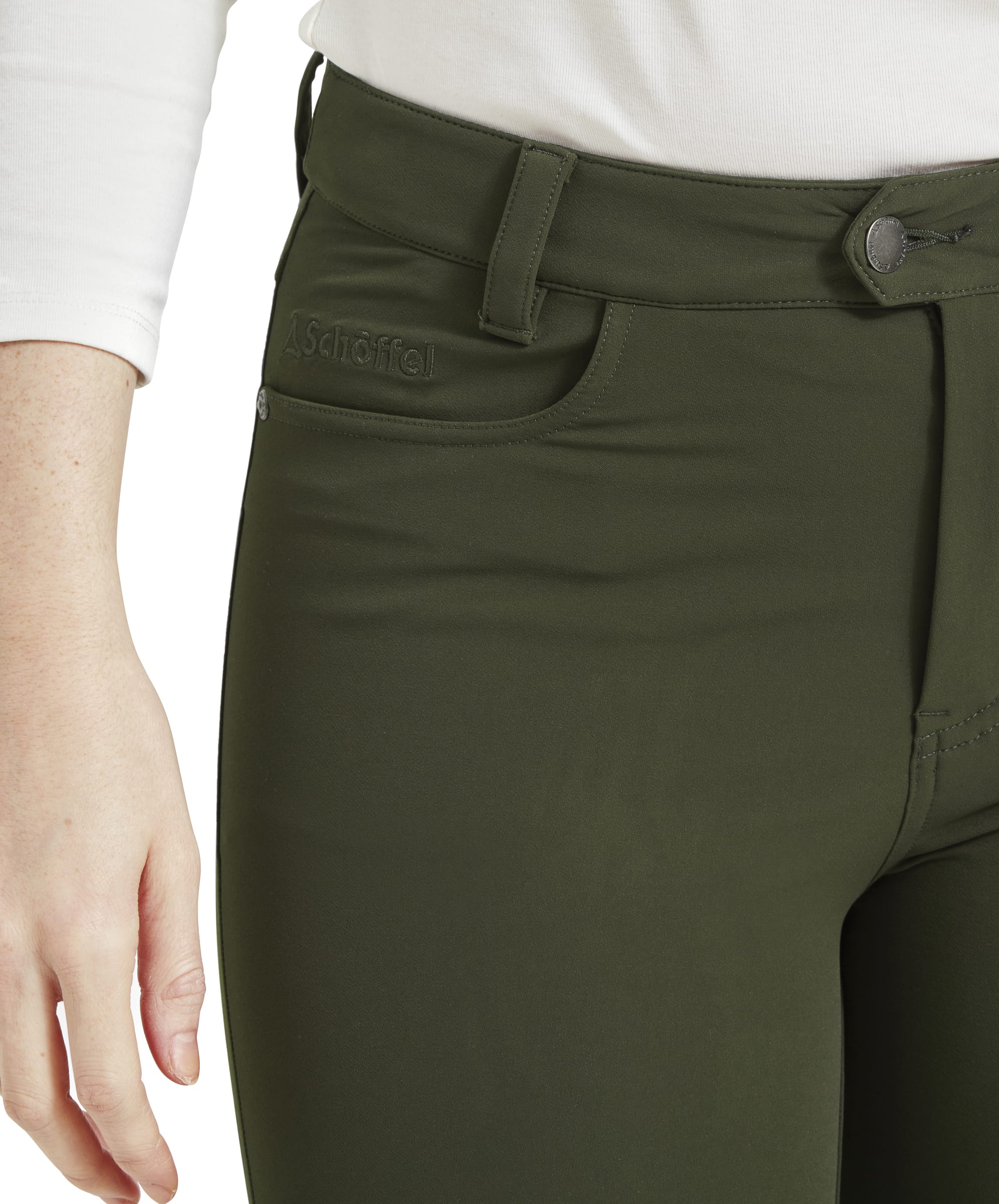 A close-up shot of the front pocket area of the Schöffel Whitwell Water Repellent Trouser for Women in Green, showing the pocket’s stitching, the waistband with belt loops, and the button closure. The embroidered brand logo can be seen near the pocket, adding a subtle design element.