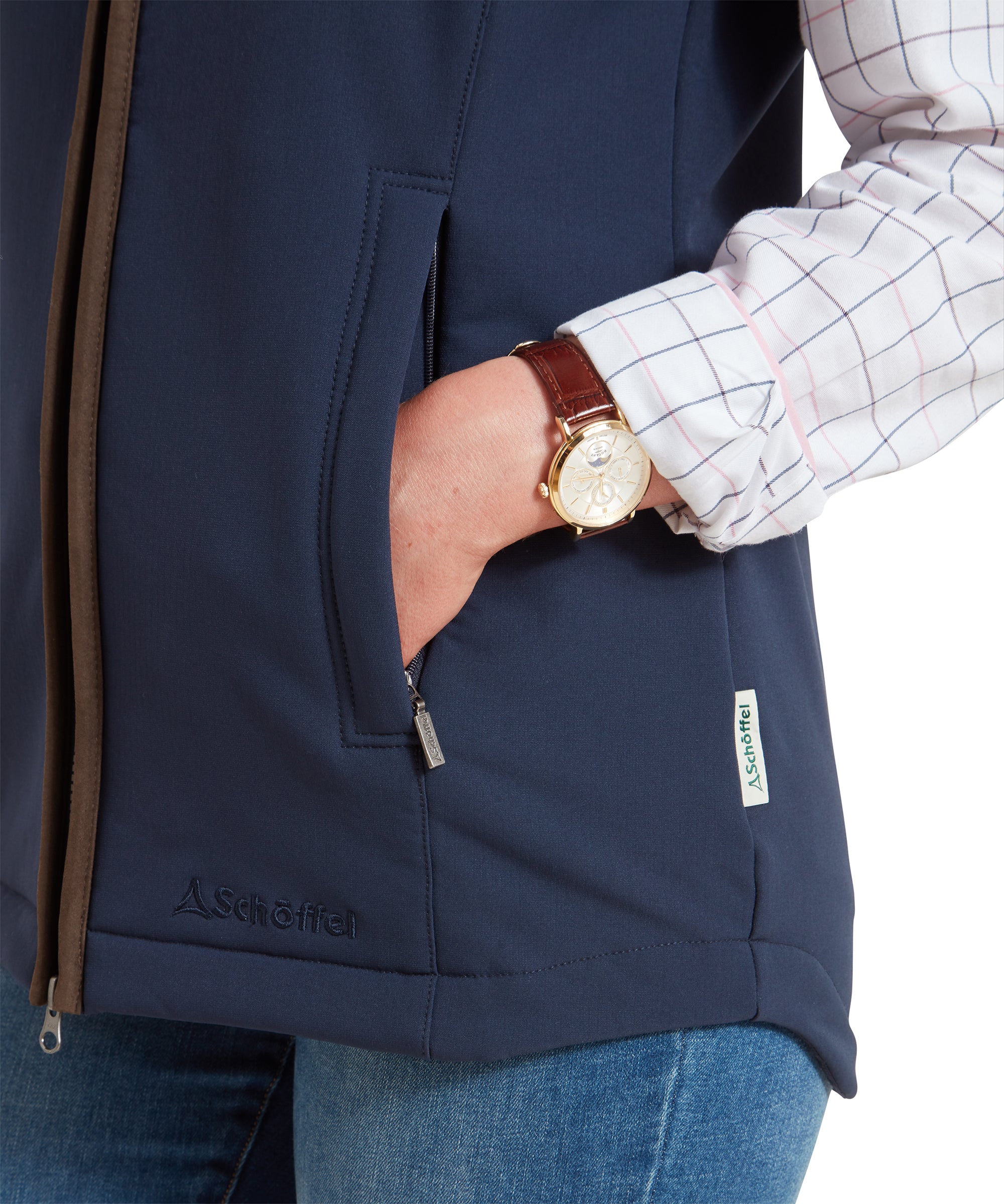 A close-up of the woman's hand in the pocket of the Schöffel Belton Gilet for Women in Navy, highlighting the zipper detail and the Schöffel logo on the gilet.