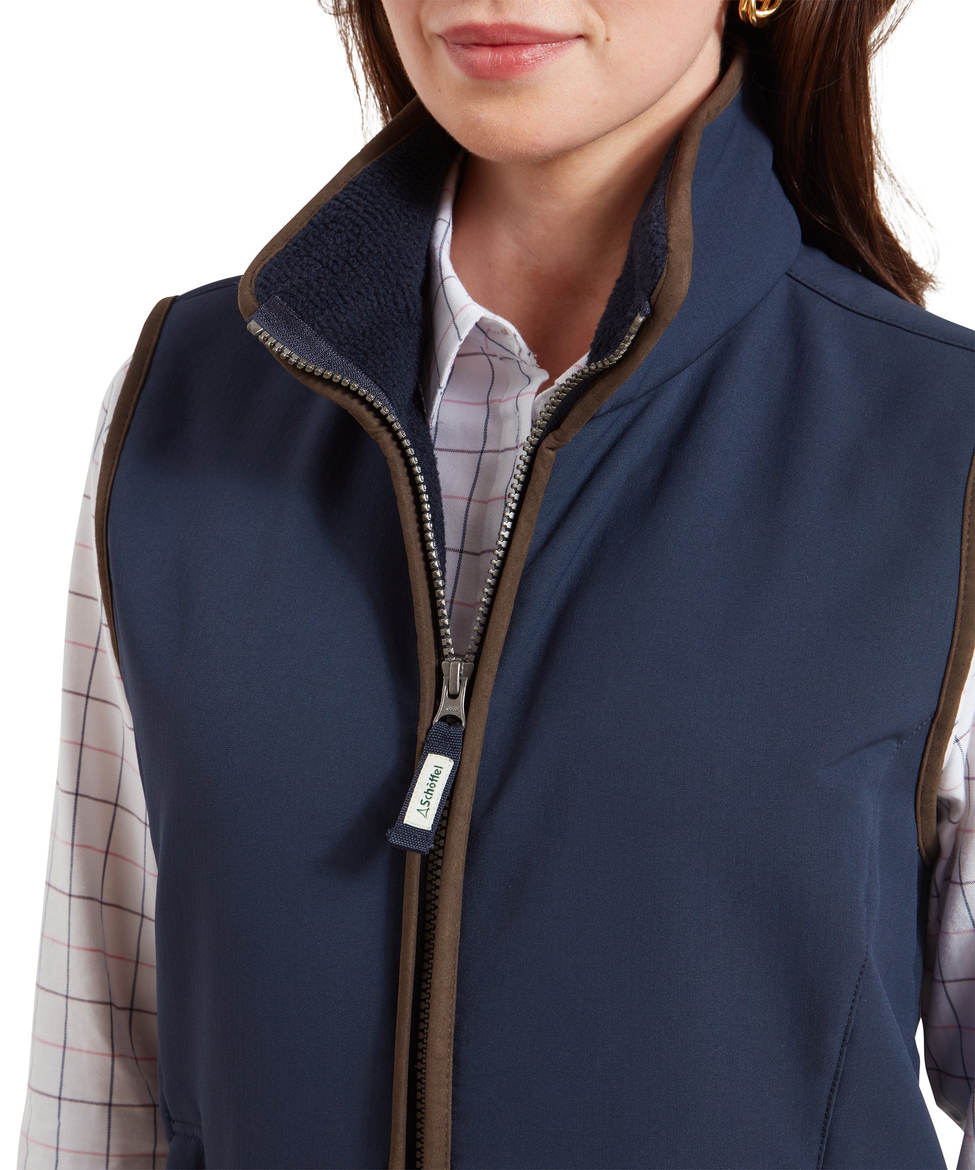 A close-up of the upper part of the Schöffel Belton Gilet for Women in Navy, focusing on the high collar and the front zipper, with a visible Schöffel-branded zipper pull.